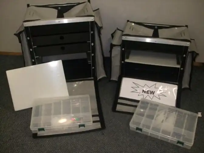 Two Rochester bait boxes open, with a bait board and tackle trays