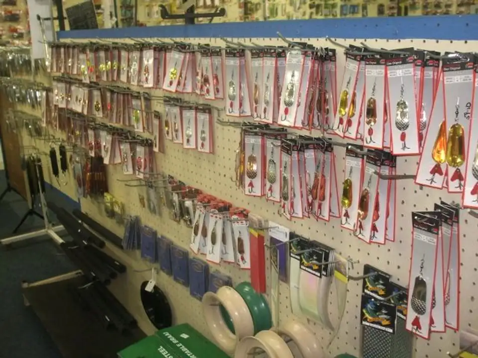 A pegboard wall of lures in their packs