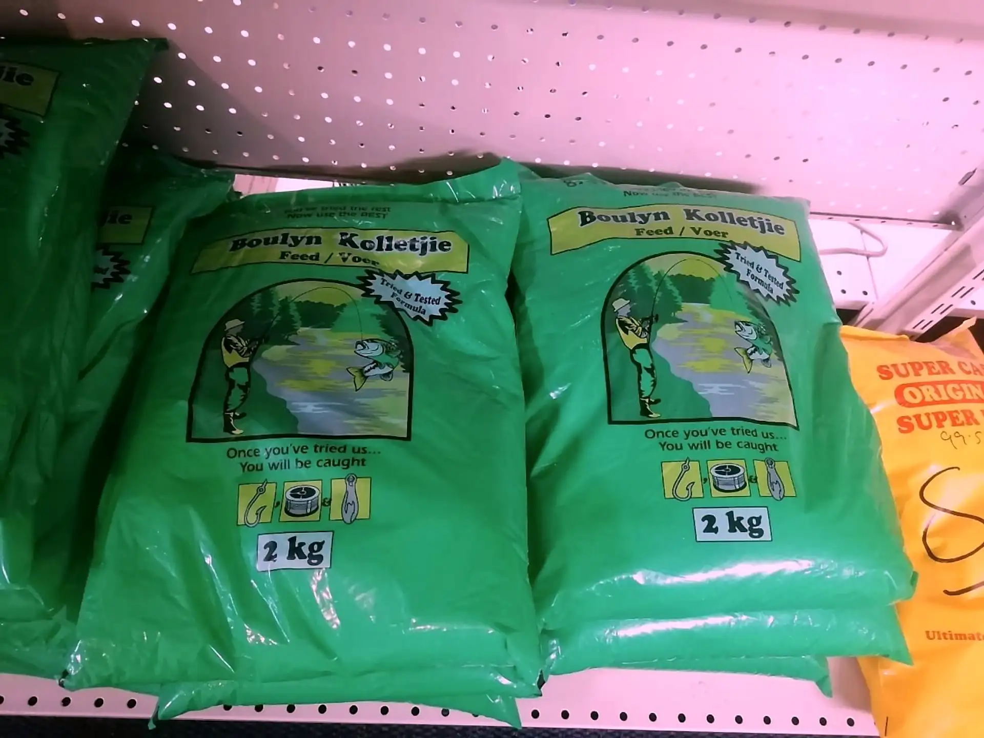 Bags of carp groundbait mix stacked in the shop