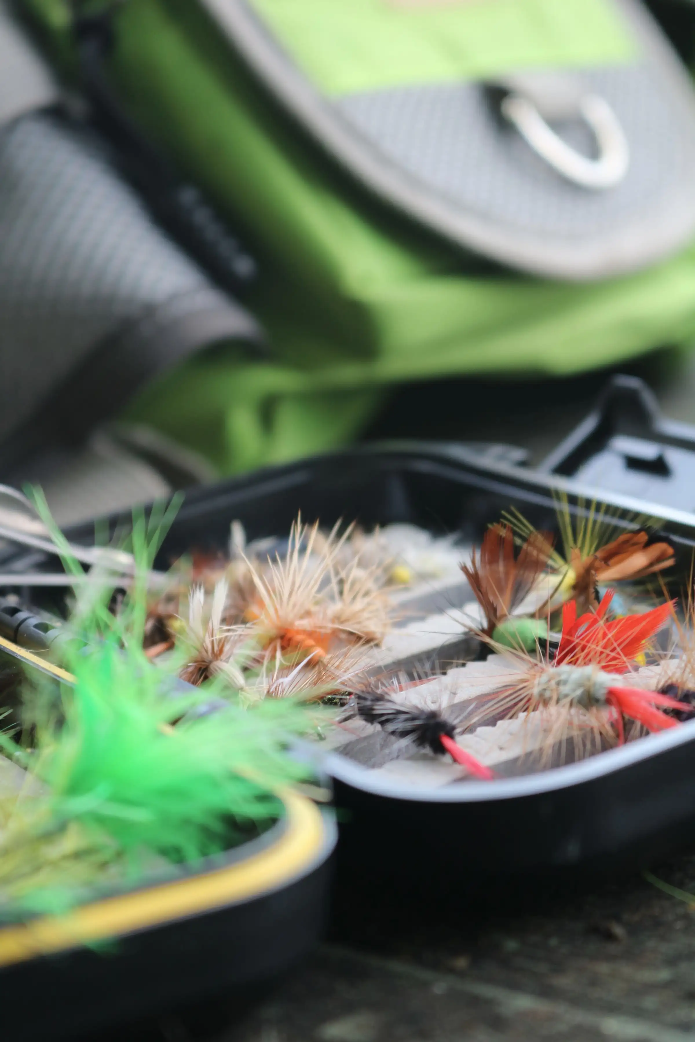 A box of colourful trout flies, close up