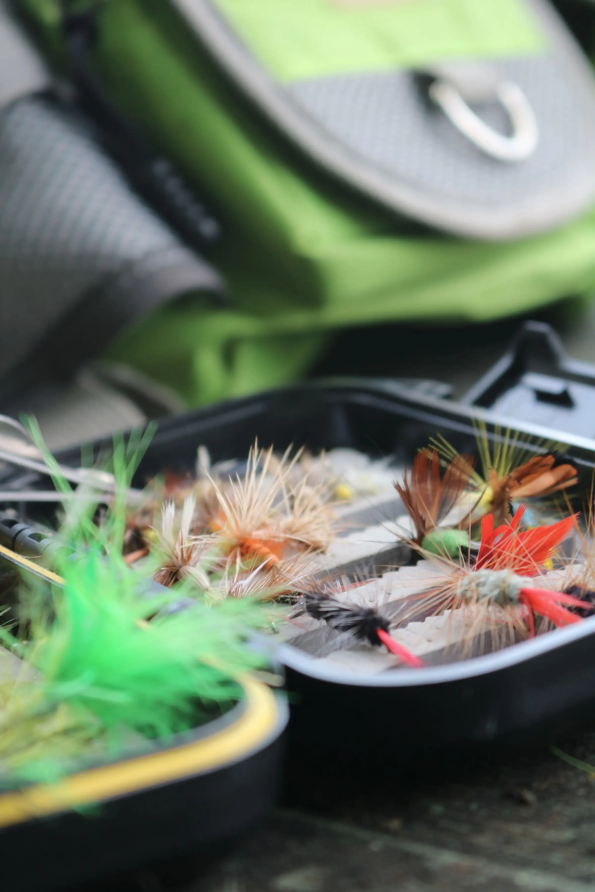 A box of colourful trout flies, close up