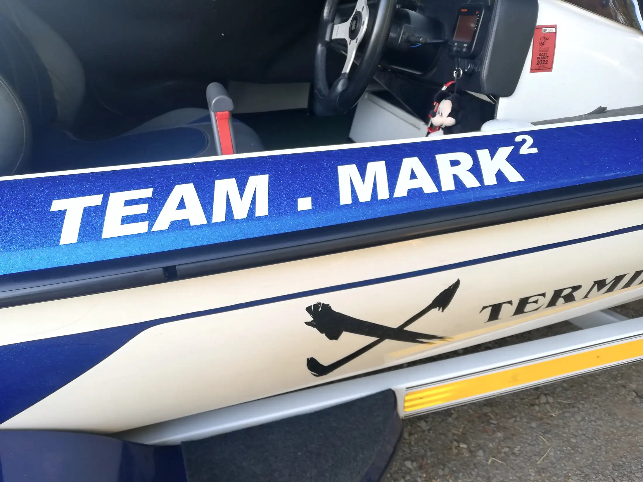 A bass boat hull with TEAM MARK² lettered on the side